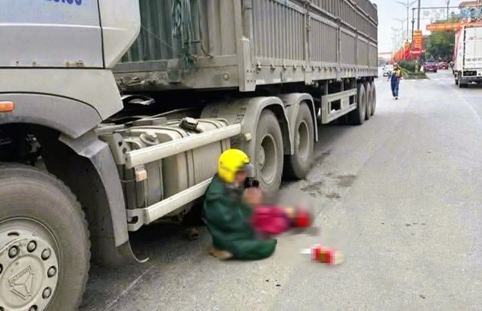 Chồng quỳ gối chắp tay bên thi thể vợ bị xe đầu kéo cán tử vong - Ảnh 1.