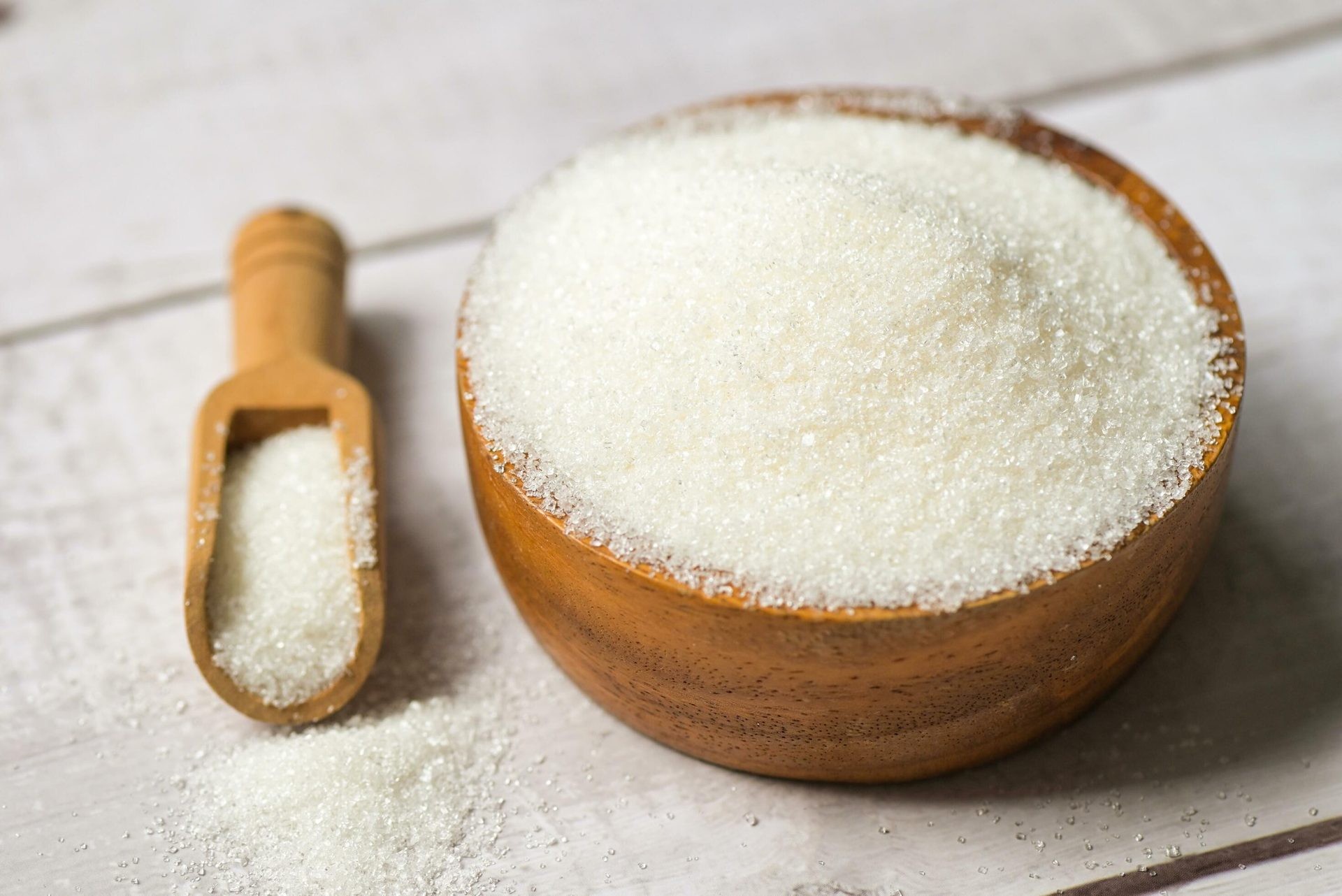 white-sugar-for-food-and-sweets-dessert-candy-heap-of-sweet-sugar-crystalline-granulated-sugar-on-wooden-background-free-photo-1792176660.jpg