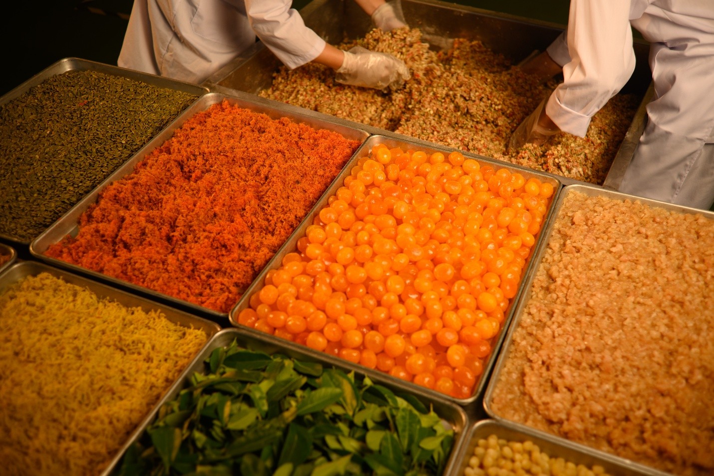 A group of metal containers with different types of foodDescription automatically generated