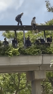 scdf-woman-woman-rescued-from-roof-of-overhead-bridge-in-serangoon-central-detained-under-mental-health-act-1743652204.gif