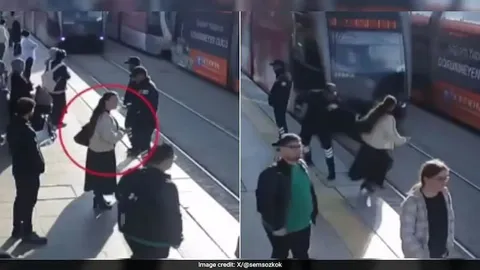 Video ghi lại cảnh bảo vệ lao đến, giữ lại người phụ nữ giúp cô thoát chết trước mũi tàu điện