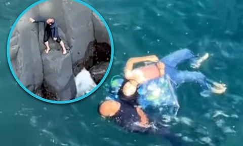 Bỏ mặc nỗi sợ và vết thương chưa lành, du khách liều mình leo lên vách đá cứu người phụ nữ khỏi chết đuối