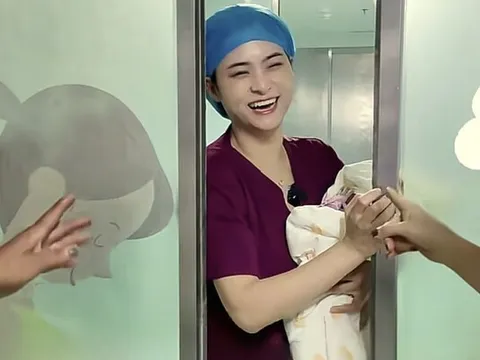 Bé sơ sinh vừa chào đời được bác sĩ bế ra ngoài gặp gia đình, đứa trẻ liên tục lấy tay che mặt
